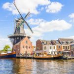 Sail boats in canal and wind mill Haarlem Netherlands
